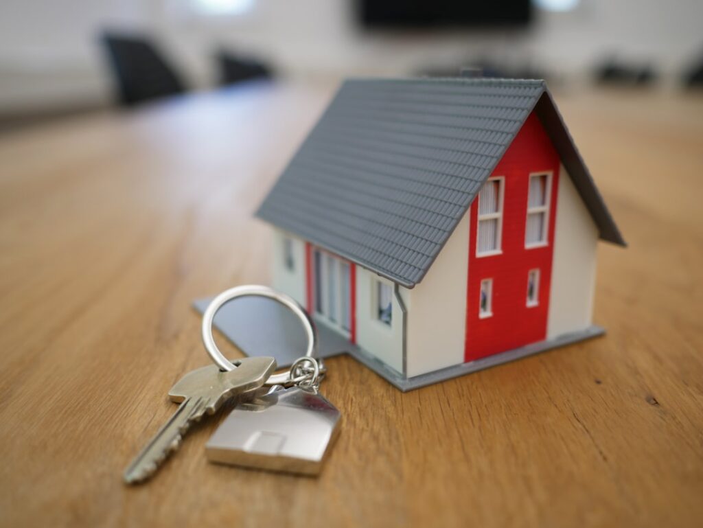 white and red wooden house miniature on brown table rgj1j8sdeay